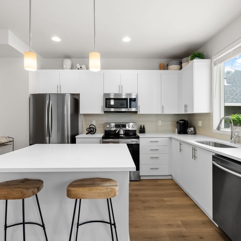 Skansie Pointe apartment interior of beautiful kitchen with stainless steel appliances, a kitchen island, and pendant lighting