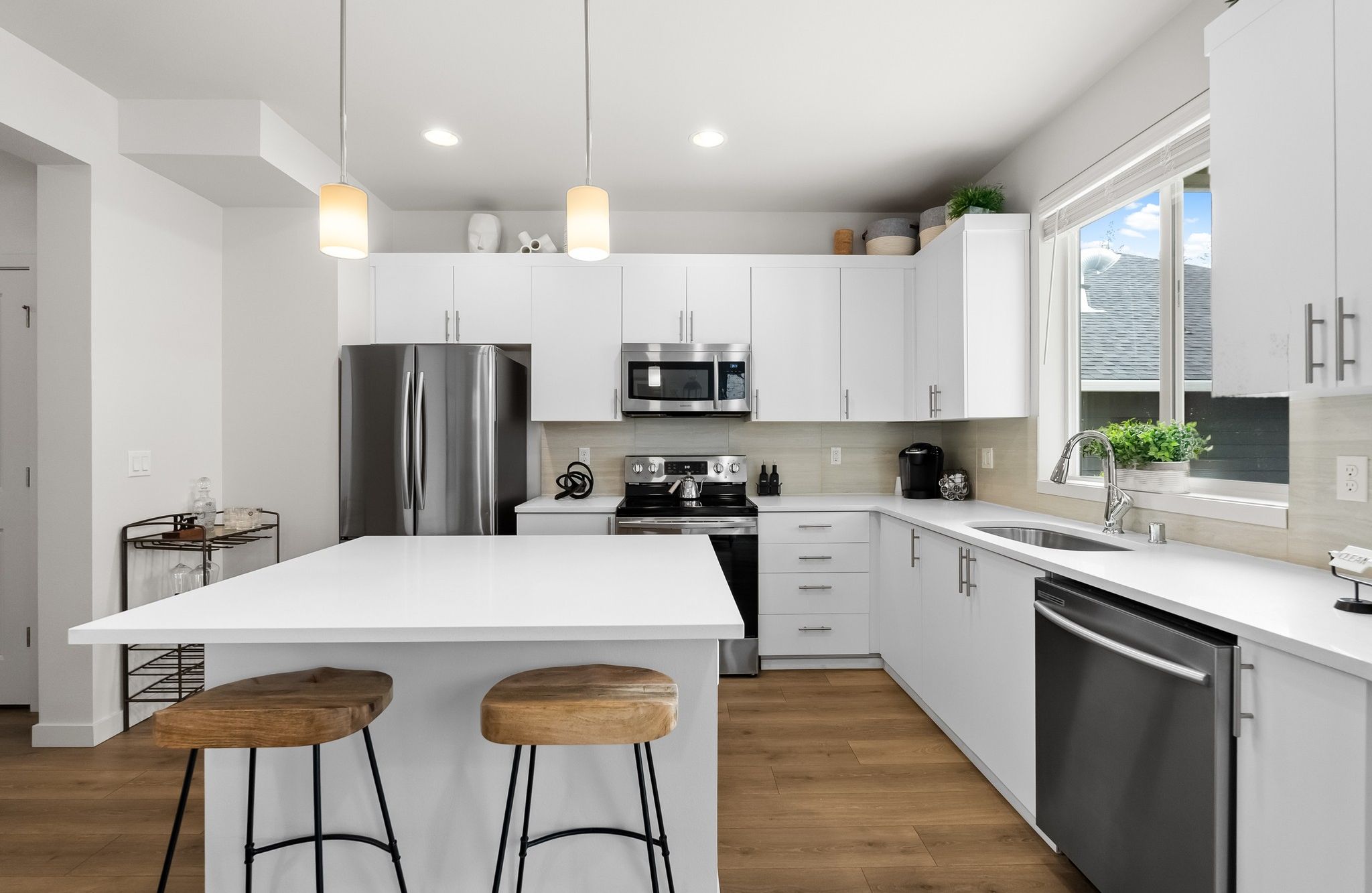 Skansie Pointe apartment interior of beautiful kitchen with stainless steel appliances, a kitchen island, and pendant lighting